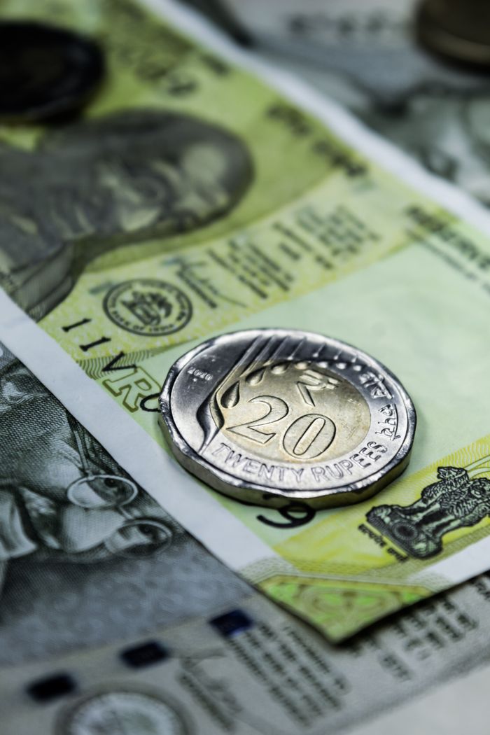 hero-img-01 Close-up photo of a 20 rupee coin on Indian currency notes, showcasing Indias financial themes.
